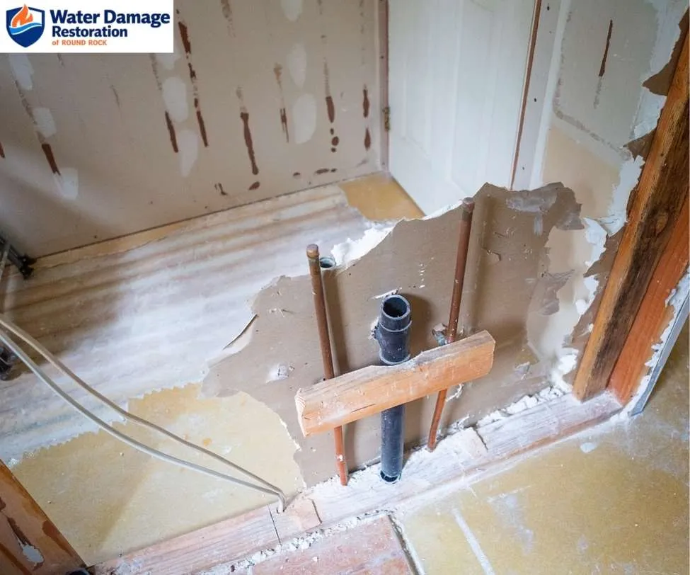 wooden wall framing studs during a flood mitigation process, as shown in water damage in Round Rock